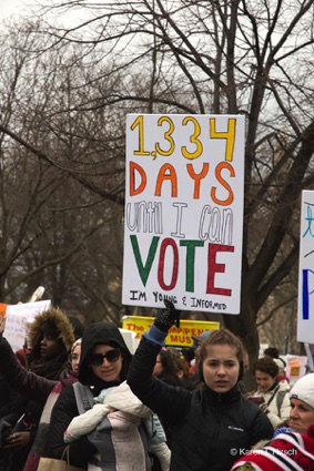Girl holding up sign 1,334 Days Until I can vote